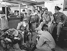 Enlisted men selecting cameras to go up in a Beechraft AT-11 on bomb-spotting missions at Roswell Army Flying School