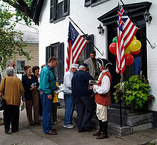 A concertina-playing guide welcomes visitors to a restored Dutch home in the Schenectady Stockade District. SchenectadyNY-StockadeDistrict.JPG