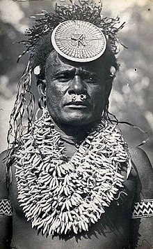 Solomon Islands chief wearing a spectacular porpoise tooth chest ornament and kap-kap. Portrait of Irobaoa of Suafa, north Malaita, circa 1910. Solomon Islands chief wearing a spectacular porpoise tooth chest ornament and kap-kap, Florida or Malaita.jpg