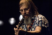 Steve Earle (pictured) co-produced the majority of Car Wheels on a Gravel Road with Ray Kennedy. Steve Earle, Cambridge Festivals 2001-2014 (966622239).jpg