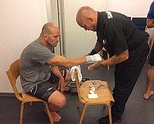 Teixeira getting hands wrapped before a fight in 2019