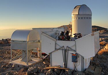 ASAS telescopes at Las Campanas Observatory. OGLE telescope visible in background. Teleskopy ASAS OGLE.jpg
