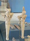 Two female figurines, Ur, Ubaid 4 period, 4500-4000 BCE. "The elongated head, similar to the figures found at Eridu, could represent an elaborate headdress or possibly cranial binding".[39]