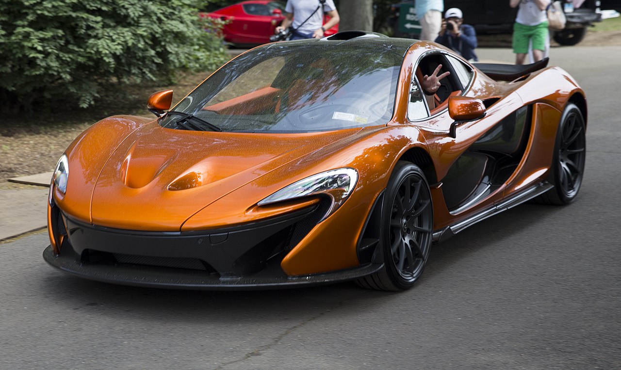 Image of 2014 McLaren P1 (Volcano Orange, front left), leaving Greenwich 2018