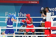 Deutsch: Boxen bei den Olympischen Jugendspielen 2018 Tag 12, 18. Oktober 2018 - Finale Fliegengewicht Mädchen – Martina La Piana (Italien, blau) schlägt Adijat Gbadamosi (Nigeria, rot) 5-0; Ringrichter ist James Beckles (Trinidad und Tobago). English: Boxing at the 2018 Summer Youth Olympics on 18 October 2018 – Girl's flyweight Gold Medal Bout - Martina La Piana (Italy, blue) beats Adijat Gbadamosi (Nigeria, red) 5-0; Referee is James Beckles (Trinidad and Tobago). Español: Boxeo en los Juegos Olímpicos Juveniles de Verano de 2018 en 18 de octubre de 2018 - Combate a medalla de oro de peso mosca para mujeres: Martina La Piana (Italia, azul) le gana a Adijat Gbadamosi (Nigeria, roja) 5-0; El árbitro es James Beckles (Trinidad y Tobago).