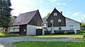 Three-sided courtyard with a stable house, two side buildings and a prayer cross