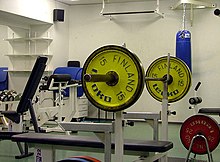 An Olympic bar mounted on a bench press bench Kuntosali.jpg