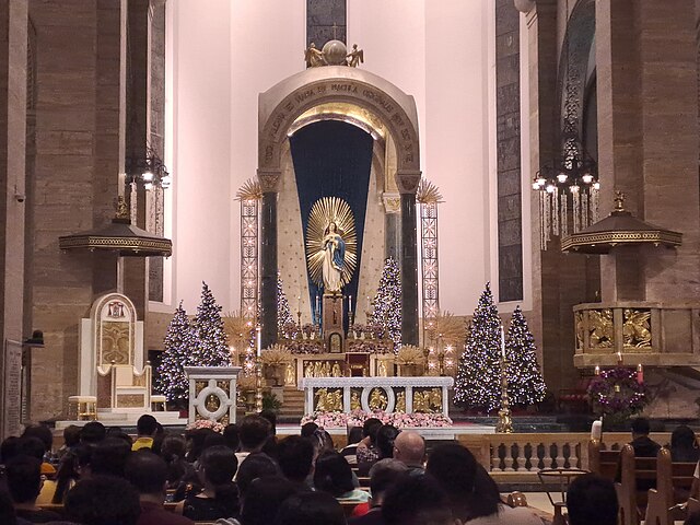 The altar of the Manila Cathedral decorated with Christmas trees for Simbang Gabi.