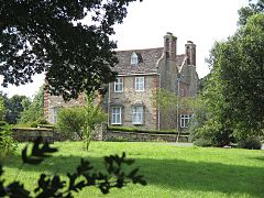 Stone house with trees in the foreground