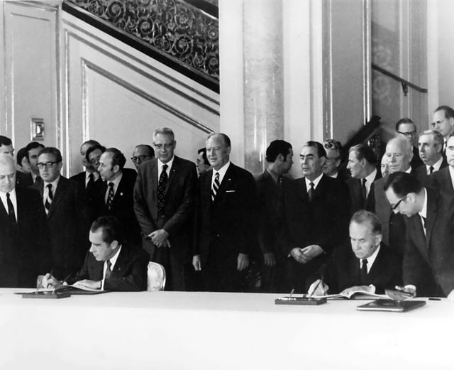 U.S. President Richard Nixon and Soviet Premier Alexei Kosygin (seated) sign an agreement in Moscow paving the way for the Apollo–Soyuz mission, May 1