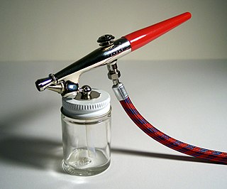 Airbrush Small, air-operated tool that sprays various media by a process of nebulization