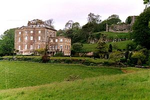 The 18th century mansion with the castle ruins in the background