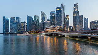 Skyline of the Central Business District of Singapore with Esplanade Bridge in the evening