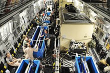 Personnel attending four dolphins during a flight aboard a C-17 Globemaster III. US Navy 091108-F-3798Y-197 Navy and Air Force personnel manage dolphins aboard a C-17 Globemaster III aircraft en route to New Caledonia.jpg