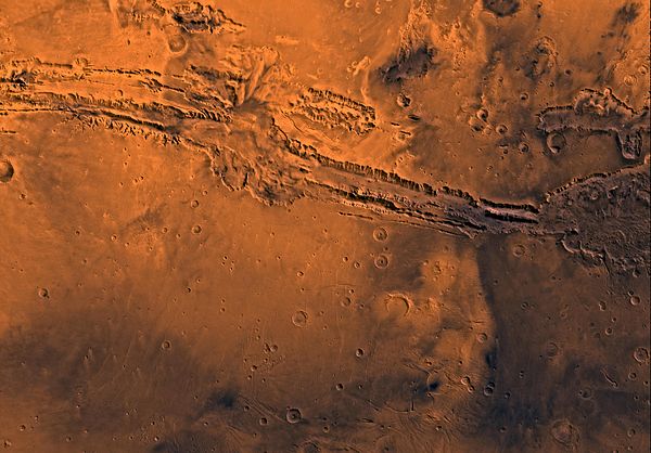 Image of the Coprates Quadrangle (MC-18). The prominent Valles Marineris chasma system intersects the moderately cratered northern part and the faulte