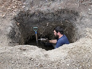 Excavating a small wood-lined privy located behind a residence which was built around 1876. Woodlined privy.jpg