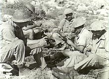 Soldiers of the 2/16th Battalion, 7th Division, fuzing Mills bombs, Damour, during the Syria-Lebanon Campaign. The division had also seen service in North Africa before being recalled to Australia. (AWM008641) AWM 008641 2nd 16th Bn syria.jpg