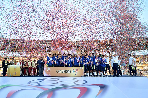 Brazilian team celebrating with the BRICS U-17 Cup trophy at the Fatorda Stadium in Goa, 2016.