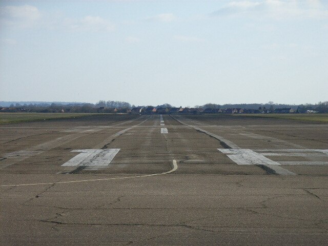 Chalgrove Airfield, looking southwards down the length of one of the runways with Chalgrove village behind.