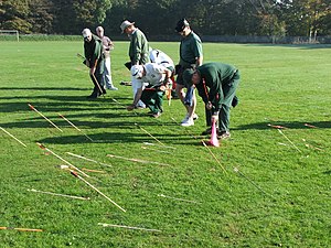 Archers collecting arrows for each scoring zone Clout Archery Collecting Arrows.jpg