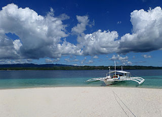 The crystal clear blue water and powdery sand of Canigao Island.