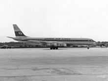 Uma fotografia em preto e branco de uma aeronave Douglas DC-8 na pista