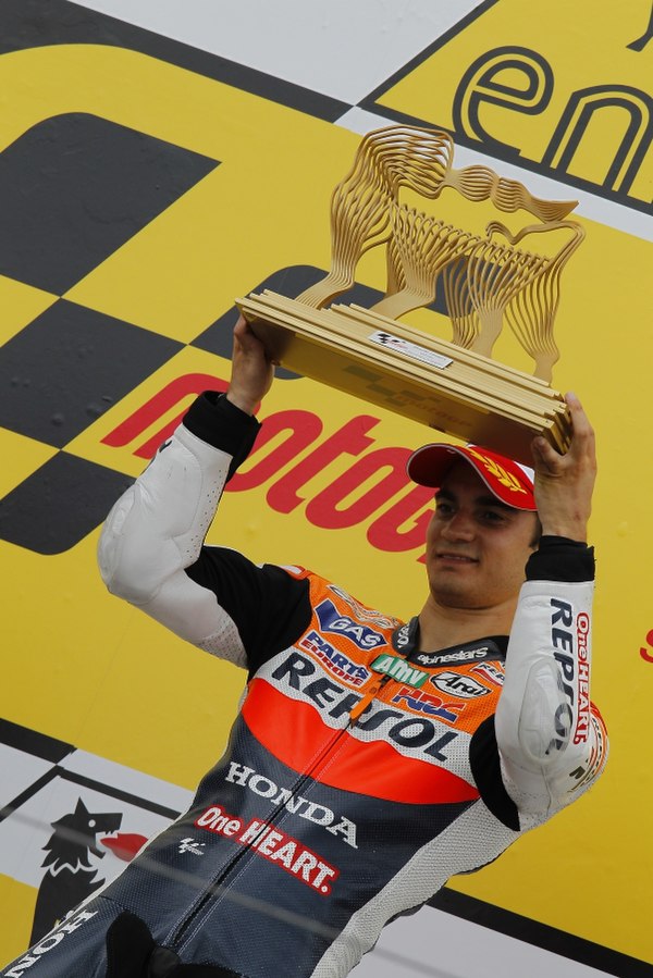 Dani Pedrosa, celebrating on the podium after winning the MotoGP race.