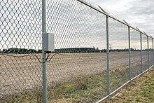 A fence-mounted perimeter intrusion detection system installed on a chain link fence. Fence-mounted perimeter intrusion detection system.jpg