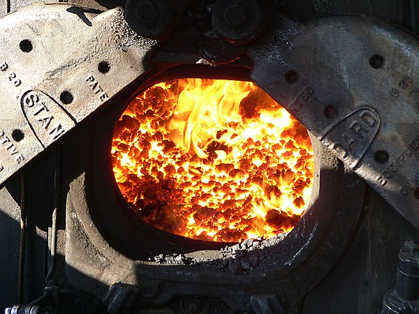 The firedoor into the firebox of a steam locomotive. The firebox peak temperature is approximately 2,500 °F (1,370 °C)