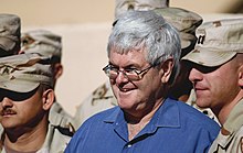 Gingrich poses with soldiers while on a visit to Kuwait in February 2003