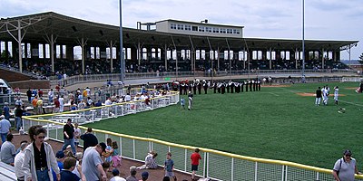 The Gill Stadium grandstand in 2004, the year the Fisher Cats played there. In the foreground is the concession and fan seating area the Fisher Cats installed adjacent to right field. The gentle curve of the grandstand is a compromise to watching football games, and creates a large foul territory for baseball. Gill Stadium grandstand, 2004.jpg