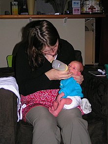 A baby being fed using the Haberman Feeder. The upright sitting position allows gravity to help the baby swallow the milk Habermanfeeding.jpg