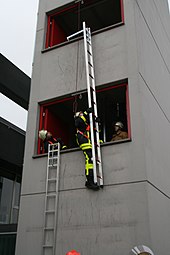 German firefighters using a modern hook ladder Hakenleiter im Einsatz.jpg