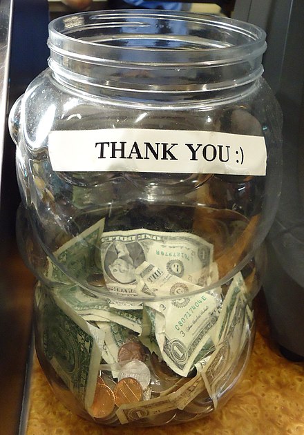 A typical tip jar in a restaurant. Tip jars are often either unlabeled or are marked with a message of thanks.