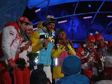 Pursuit & Individual - visually impaired. From left to right: Bronze medalists Alexey Ivanov (guide) and Mikhalina Lysova of Russia, gold medalists Thomas Friedrich (guide) and Verena Bentele of Germany, and silver medalists Natalia Yakimova (guide) and Lioubov Vasilieva of Russia. Medalists for the Women's Visually Impaired Biathlon, their guides also get medals!.jpg