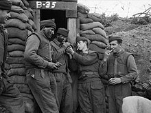 Soldiers of Duke of Wellington's Regiment the Battle of the Hook, 1953 Men of the 1st Battalion, The Duke of Wellington's Regiment, have a smoke while waiting for dusk to fall before joining a patrol into no-man's land at The Hook.jpg