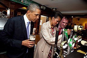 Michelle Obama pours a pint of stout