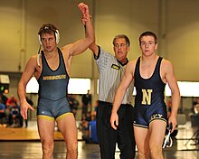 A Missouri wrestler (left) after winning a match against a Navy Midshipmen wrestler in 2012 Missouri Wins.jpg