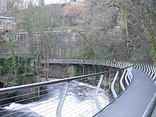 The Millennium Walkway showing the part cantilevered from the railway embankment, and the part supported by pillars set in the river bed