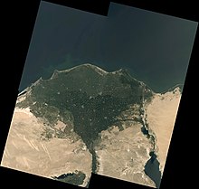 The heavily-populated Nile delta, showing an arcuate margin shaped by longshore drift Nile River Delta, Egypt (34309720823).jpg