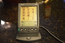A Palm IIIe sitting in its HotSync cradle. Palm IIIe in HotSync Cradle.jpg