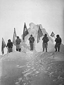 Robert Peary and sledge party with flags at North Pole. Peary has been claimed to be the first person to reach the north pole. Peary Sledge Party and Flags at the Pole.jpg