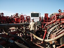 Example of high pressure manifold combining pump flows before injection into well Process of mixing water with fracking fluids to be injected into the ground.JPG