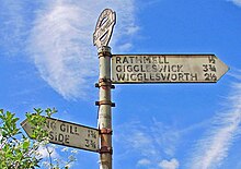 Signpost near the village showing directions to local communities and recording the pre-1974 location within Yorkshire West Riding Rathmell Yorks WR Signpost 2016.06.03.jpg
