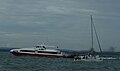 Red Funnel Red Jet 5, seen in Cowes, Isle of Wight, leaving a rather large cloud of black smoke behind it.