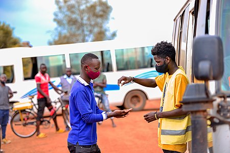 4th : Rwanda youth volunteer sanitizing people at Rutonde bus station to fight against covid-19 by Davyimage