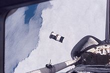 As seen through windows on the aft flight deck of Space Shuttle Discovery, a Department of Defense picosatellite known as Atmospheric Neutral Density Experiment (ANDE) is released from the shuttle's payload bay. STS-116 ANDE Released (S116-E-07828).jpg