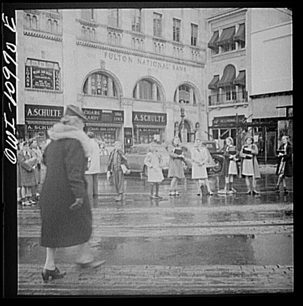 File:School children waiting for buses in the rain8d23392v.jpg