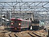 A 115 series train and a freight train at Sakaki Station in March 2008