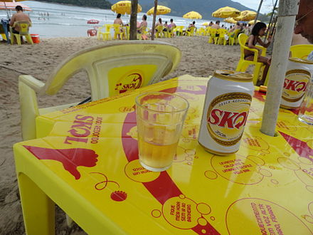 Skol cans and tables at the beach in Brazil
